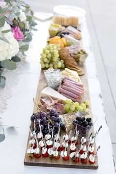 a long table filled with lots of different types of cheese and crackers on top of it