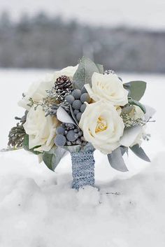 a bridal bouquet sitting in the snow