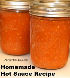 three jars filled with homemade hot sauce sitting on top of a counter