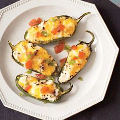 four stuffed peppers on a white plate