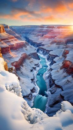 the sun is setting at the edge of a canyon with a river running through it