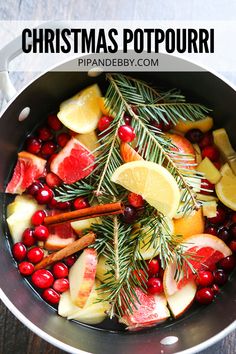 a pot filled with fruit and spices on top of a wooden table