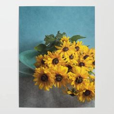 a bouquet of sunflowers sitting on top of a green plate next to a blue wall