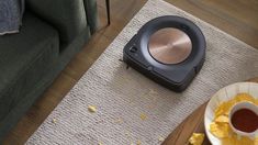 a roombake is on the floor next to a bowl of chips