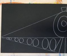 a black piece of paper with a drawing of a train on it