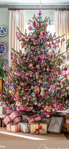 a decorated christmas tree with presents under it