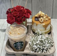 there is a cake, coffee and flowers on the tray with roses in vases