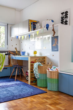 a child's bedroom with blue and green decor on the walls, wooden flooring and shelves