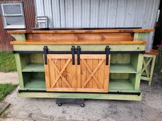 an outdoor bar made out of wood and metal with sliding doors on the front door