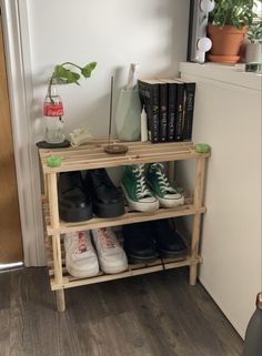 two pairs of shoes are sitting on a shelf in front of a door and bookshelf