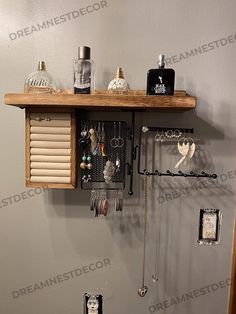 a wooden shelf with jewelry hanging from it's sides and other items on the shelves