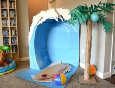 there is a fake surfboard and palm tree in the room with bookshelves