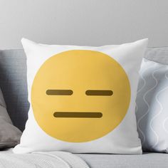 a yellow smiley face on a white pillow