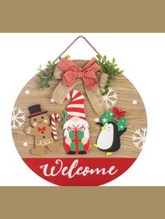 a wooden sign that says welcome with christmas decorations