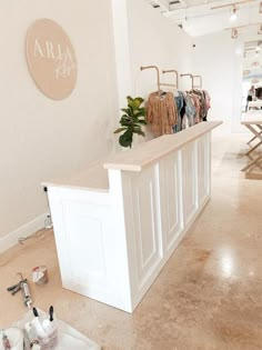 the inside of a clothing store with clothes on display