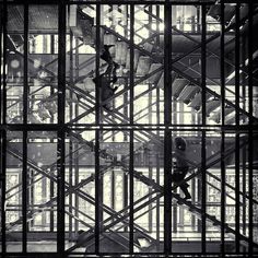 black and white photograph of stairs in an industrial building with scaffolding on the walls