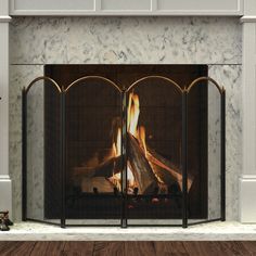 This four panel firescreen is made to keep your home safe and warm. This versatile, lightweight fireplace screen from the open hearth collection features four equally arched black panels topped with an antique brass frame. The size 4 mesh screen makes this the perfect fireplace screen to protect your hearth from flying embers. Each panel is 12.75-inch wide and folds in either direction to adjust to almost any size of fireplace opening. This fully assembled screen folds compactly for seasonal storage. Lowe's 50-in Black and Antique Brass Steel 4-Panel Arched Fireplace Screen | 15106 Fireplace Grate Ideas, Diy Fireplace Screen, Spanish Revival Fireplace, Arched Fireplace Screen, Fireplace Cover Ideas, Fireplace Screen Ideas, Extra Wide Fireplace Screen, Black Arch Fireplace Screen, Fireplace Guard