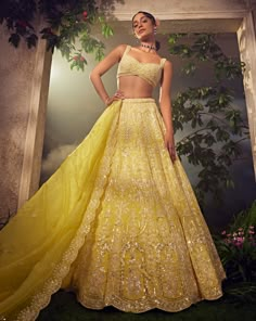 Featuring a prime yellow organza lehenga embroidered fully by hand with various ornamental sequences and Japanese bugle beads. It is paired with a scallop dupatta and a stylised blouse .From Aneesh Agarwaal's Ellora collection.DELIVERY TIMEPlease allow 8-12 weeks for your outfit to arrive.FABRIC DETAILSNetProfessional cleaning only. Summer Lehenga Designs, Pastel Yellow Lehenga, Yellow Wedding Lehenga, Yellow Organza Lehenga, Indian Ghagra, Yellow Bridal Lehenga, Yellow Lengha, Desi Lehenga, Lengha Designs