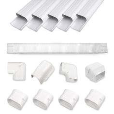 an assortment of white plastic parts including pipe, gutter and drainage hoses on a white background