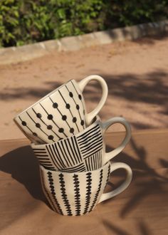 three coffee cups are stacked on top of each other