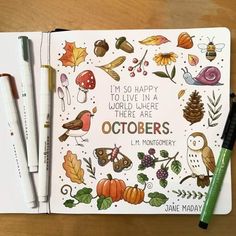 an open notebook with markers and pencils on top of it, surrounded by autumn themed items