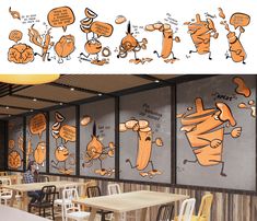 the interior of a restaurant with cartoon drawings on the walls and tables in front of them