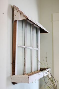 an old window is hanging on the wall