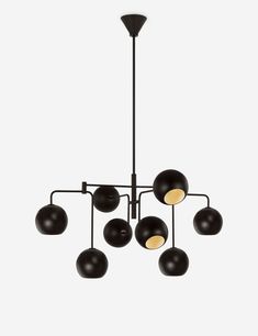 a chandelier with eight black balls hanging from it's center, and five lights on each side