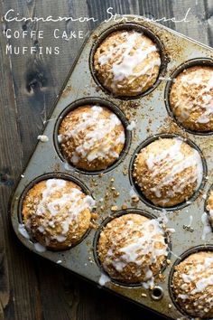 a muffin tin filled with cupcakes covered in icing