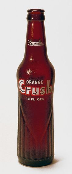 an orange crush soda bottle sitting on top of a table