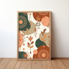 an art print on a wooden frame in front of a white wall with wood flooring