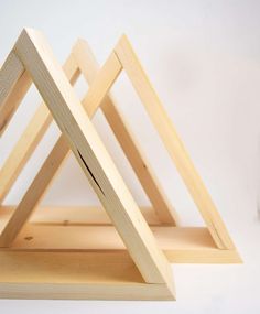 an advertisement for the interior triangle shelf show, featuring two pieces of wood stacked on top of each other