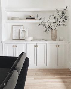 a living room filled with furniture and white walls