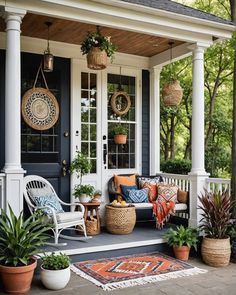 the front porch is decorated with potted plants and wicker baskets