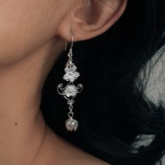 These handcrafted Hmong silver floral earrings are inspired by the traditional Hmong and Miao Minority Tribes jewelry. They are unique and delicate to wear on some occasions such as wedding, birthday party etc. and and would make a lovely gift as well. Materials: s999 Sterling Silver Length: 67mm Drop Length: 49.5mm Width: 16.1mm Weight: 2.7g*2   Cyan Art Store creates dainty jewelry that is inspired by antique and tribal designs from around the globe.   All of our pieces are handmade so keep in Cherry Blossom Earrings, Unique Bridesmaid, Dangle Earrings Silver, Earrings Nature, Flower Dangle Earrings, Silver Flower Earrings, Earrings Unique, Floral Earrings, Bridesmaid Earrings