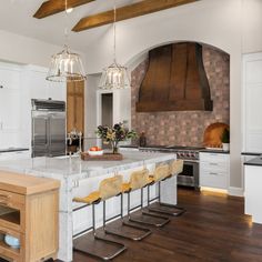 a large kitchen with an island, stove and oven in it's center area