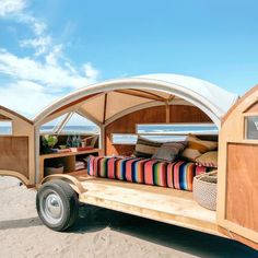 a trailer with a bed in it on the beach