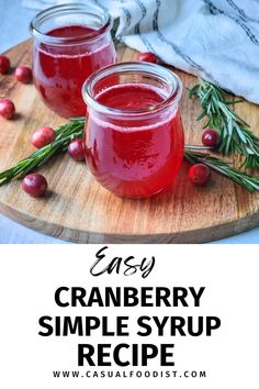 cranberry simple syrup recipe on a wooden cutting board with rosemary sprigs