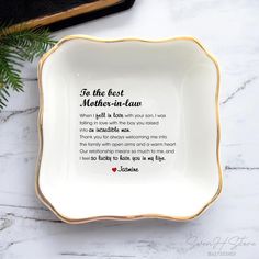 a white and gold plate with the words to the best mother - in - law