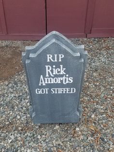 a tombstone with the words rip rick amrots got stiffed on it in front of a red door