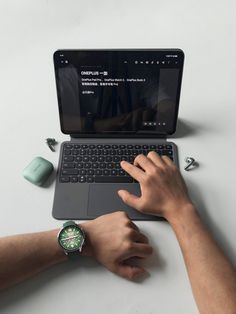 a man is typing on his laptop computer