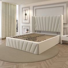 a white bed sitting on top of a wooden floor