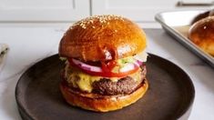 a hamburger sitting on top of a black plate