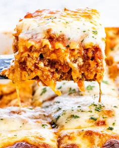 a slice of lasagna being lifted from a casserole dish with cheese