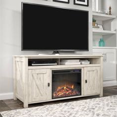 an entertainment center with a fireplace in the middle