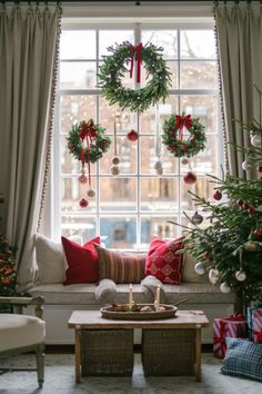 Christmas living room with decorated window and wreaths Christmas Window Sill Decorations, Home Decor Holiday, Christmas Window Decorating Ideas, Large Window Christmas Decor, Big Window Christmas Decor, New Year Window Decoration, Christmas Window Seat Decorations, Windows Christmas Decoration, Xmas House Decor