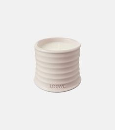 a white candle holder with the word love on it