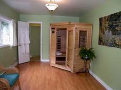 an empty room with a wooden cabinet in it