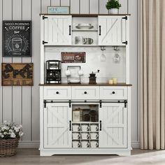 an old fashioned white kitchen cabinet with open doors and shelves on the side, next to a potted plant