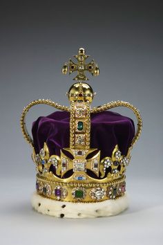 a gold crown with purple velvet and jewels on the front, set against a gray background